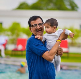 boy-in-blue-shirt-carrying-baby-in-white-onesie.jpg boy in blue shirt carrying baby in white onesie